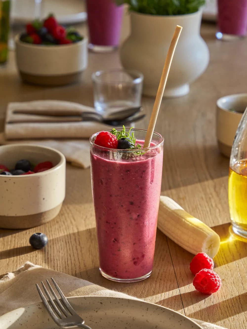 Berry protein smoothie with a paper straw