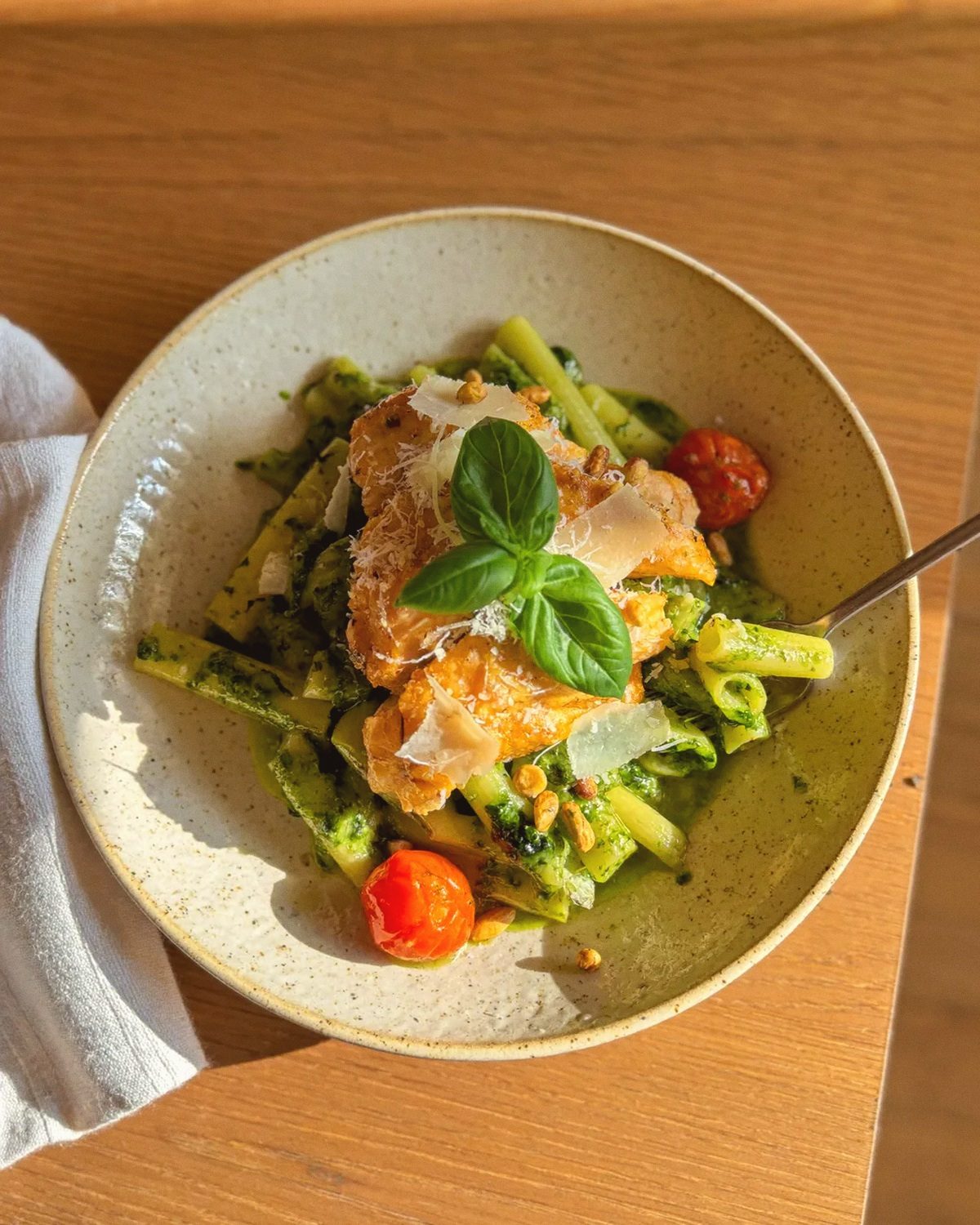 A bowl of pesto pasta with chicken and basil, the dish izeeva reworks