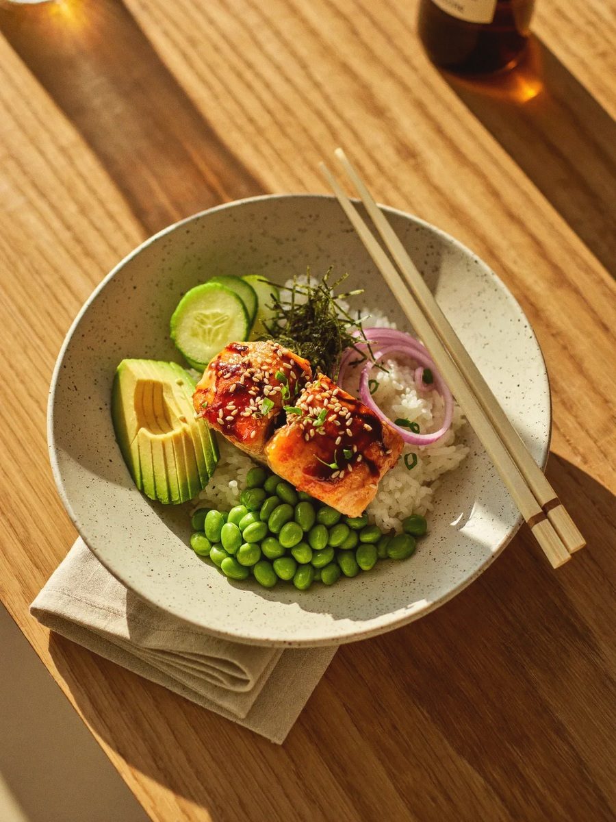 Teriyaki salmon rice bowl with edamame, avocado and cucumber